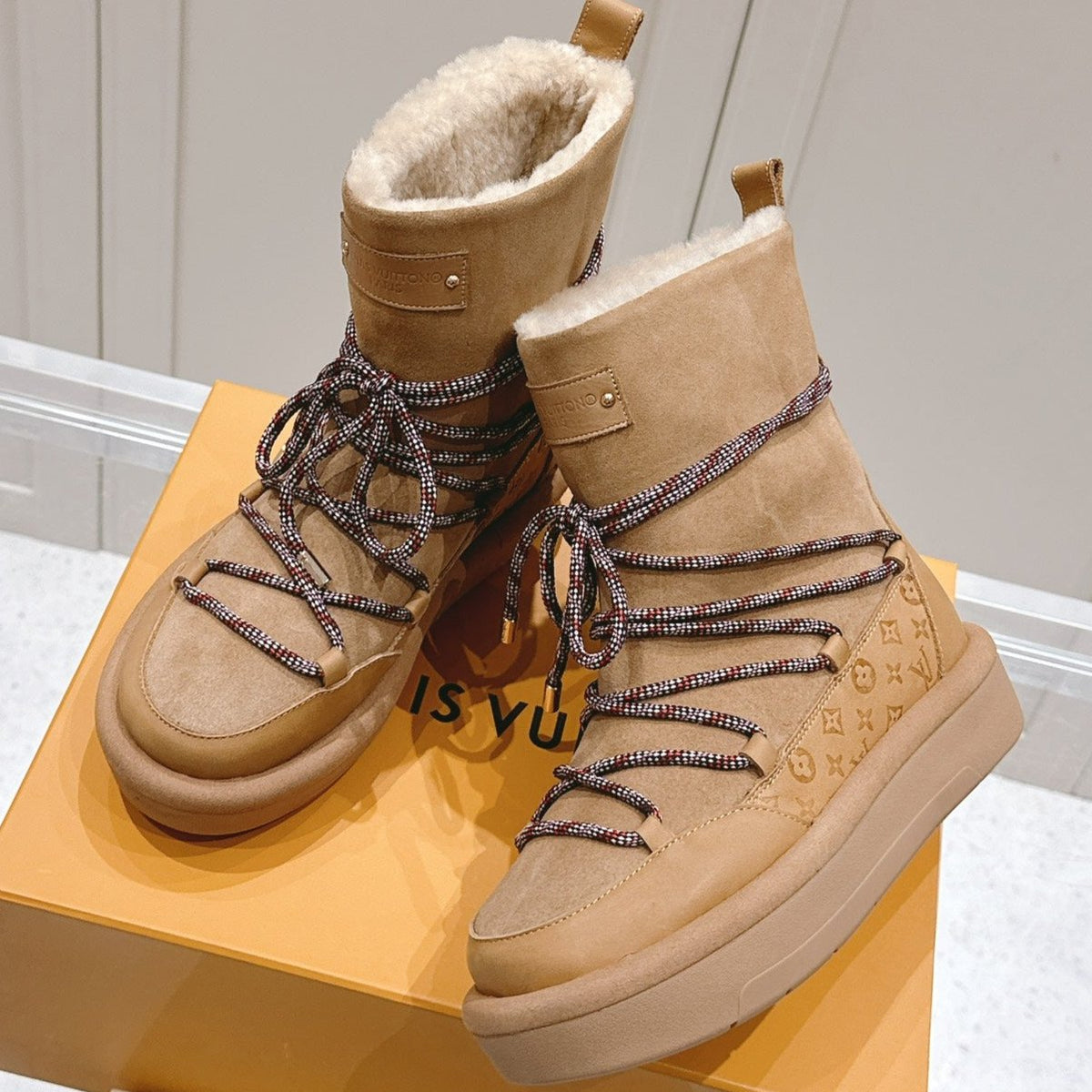 ASPEN PLATFORM ANKLE BOOT IN CIDER BROWN MONOGRAM DEBOSSED SUEDE AND SHEARLING